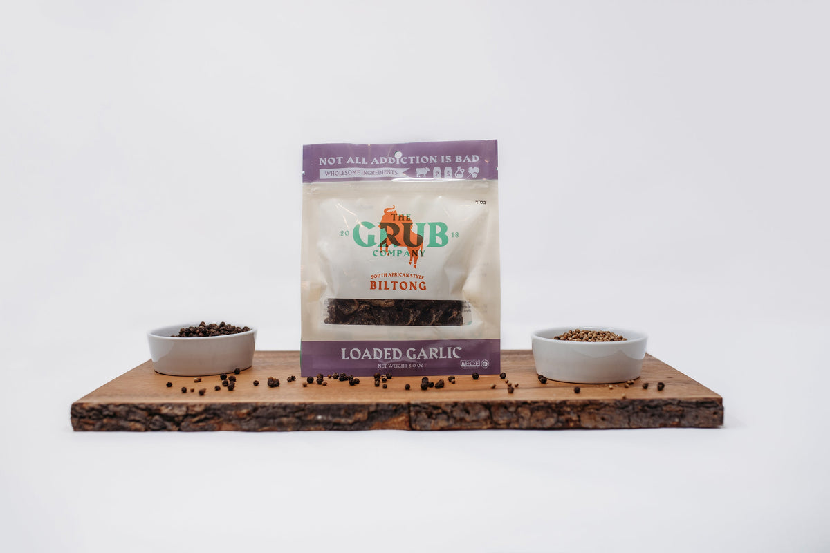 Two biltong pouches on a wooden serving board