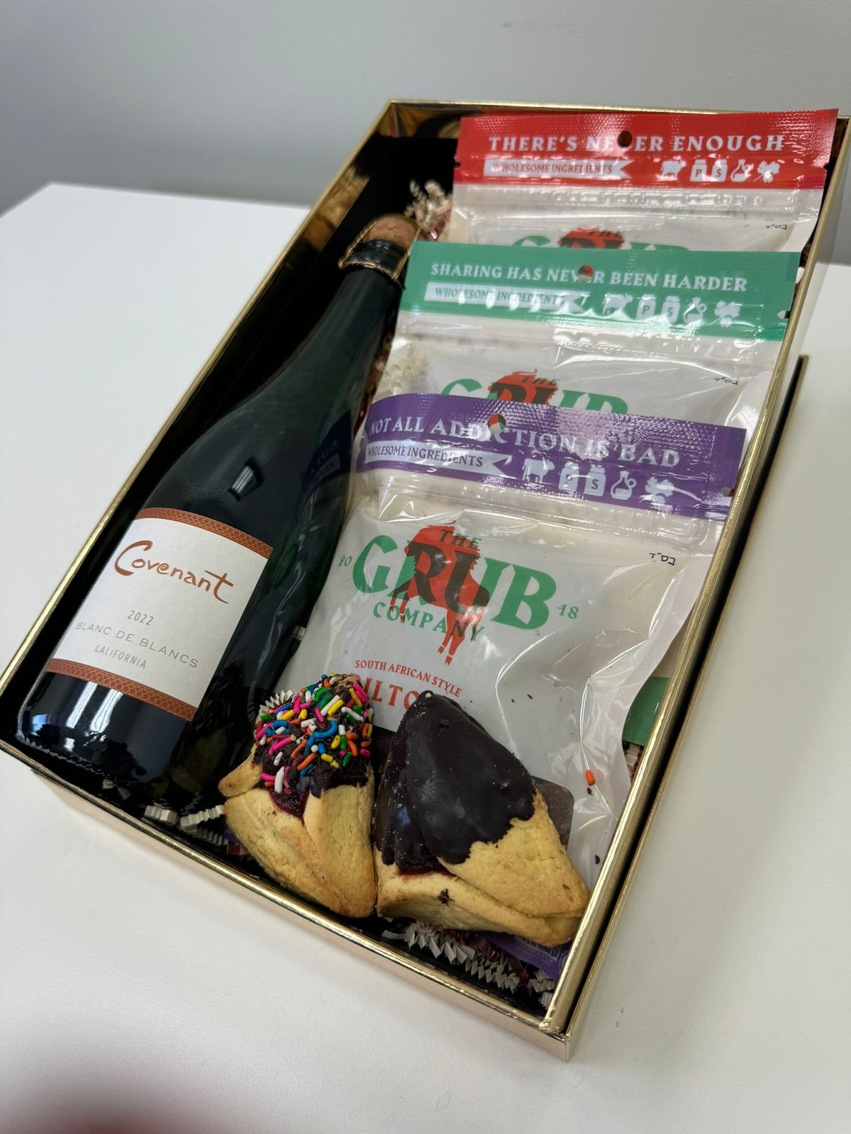 A gift box packed with biltong pouches and a bottle of wine