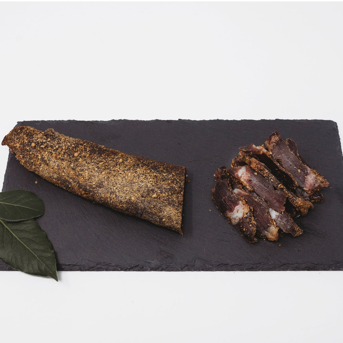A biltong slab resting on dark slate