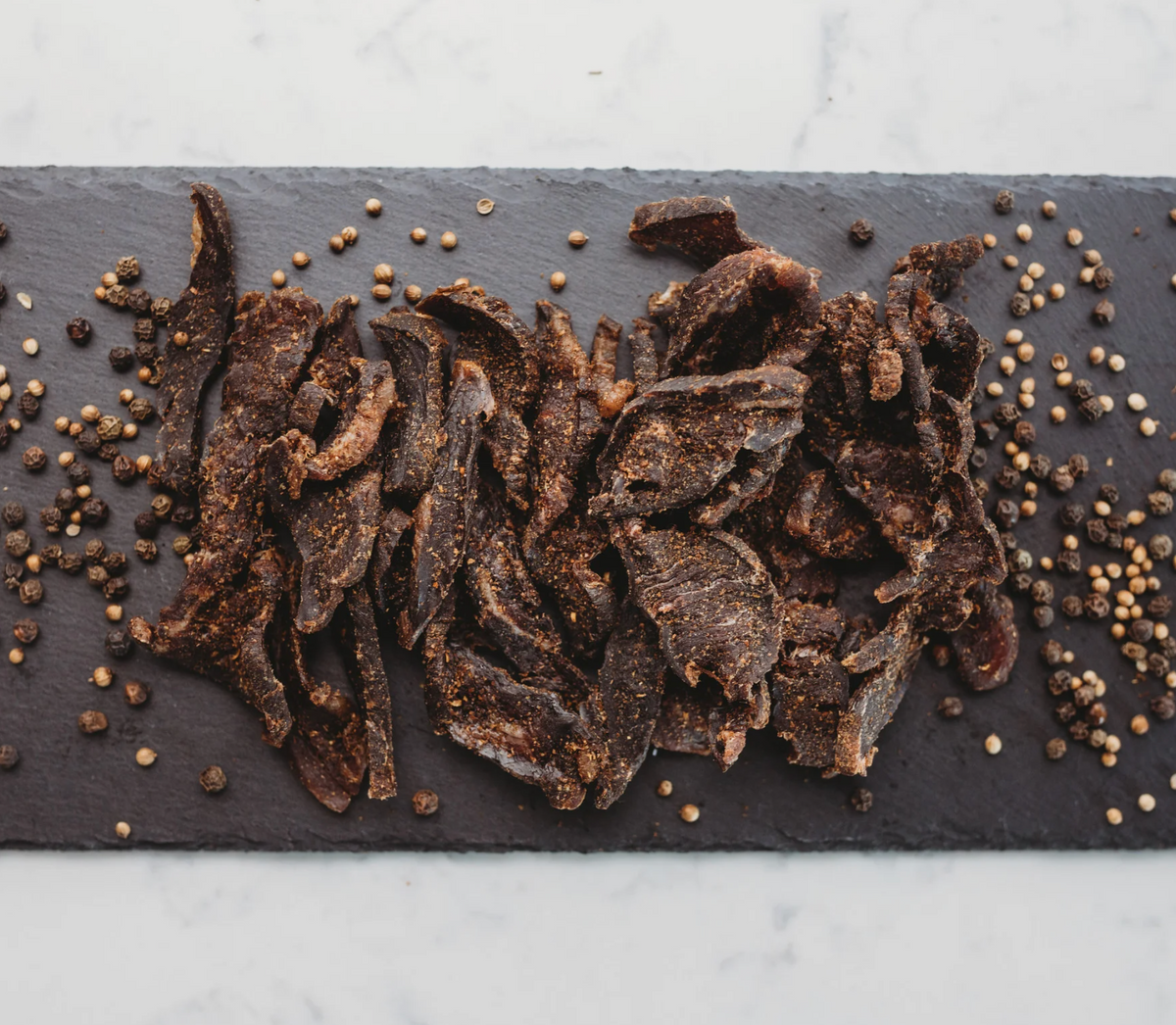 A pouch of biltong on a dark board