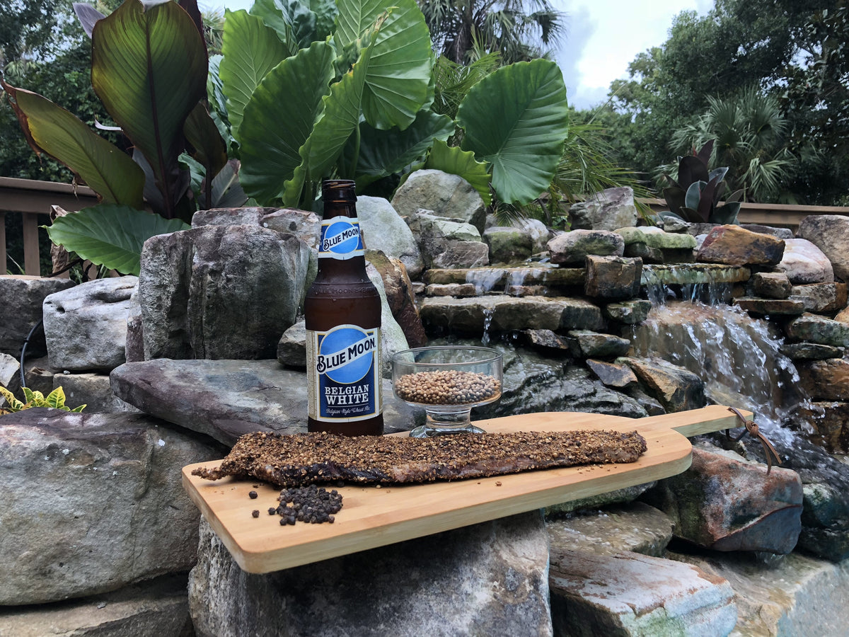 A biltong slab on a dark board